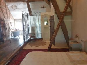 an attic room with a bed and a bathroom at Charming room in Sornay