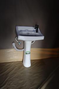 a white sink sitting on top of a bed at Elephant trails camp in Sekenani