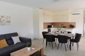 a living room with a table and a couch at Villa GB in Brtonigla