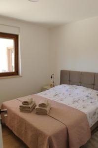 a bedroom with a bed with two towels on it at Villa GB in Brtonigla +22 photos