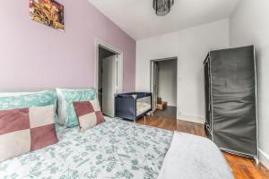 a bedroom with a large bed with a gray closet at Maison conviviale à Bourbon-Lancy avec équipements modernes in Bourbon-Lancy