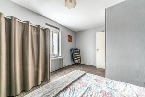 a bedroom with a bed and a window at Maison conviviale à Bourbon-Lancy avec équipements modernes in Bourbon-Lancy