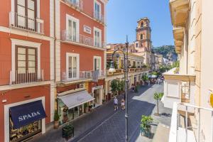 a city street with buildings and a clock tower at Maison Il Corso in Sorrento