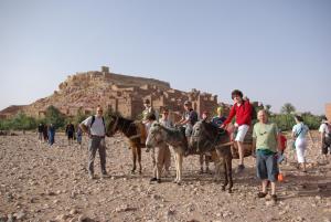 a group of people riding on the backs of horses at Maison d'Hôtes Nouflla in Aït Benhaddou