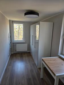 an empty room with a table and a window at Majowy in Siedlce