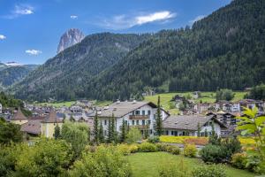 a town in a valley with mountains in the background at Tito Apartments in Ortisei