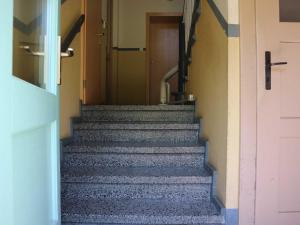 a set of stairs in a hallway with a door at Ferienwohnung MIWE Gesundheitszent in Forst