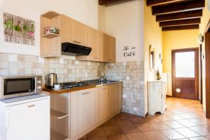 a kitchen with a sink and a stove top oven at Charming House in Vesime with Shared Pool in Vesime