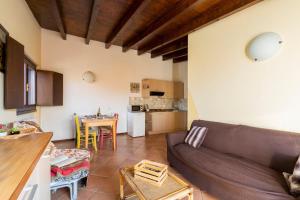 a living room with a couch and a table at Charming House in Vesime with Shared Pool in Vesime