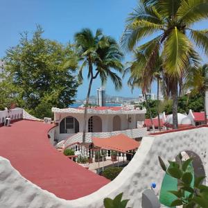 a skateboard ramp in front of a resort with palm trees at CH Paradise Condesa in Acapulco