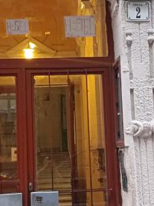 a front door of a building with signs on it at Station Backpackers in Budapest