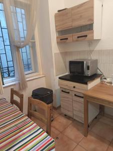 a kitchen with a microwave on top of a counter at Station Backpackers in Budapest