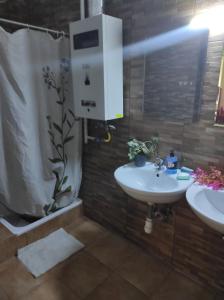 a bathroom with a white sink and a shower at Station Backpackers in Budapest