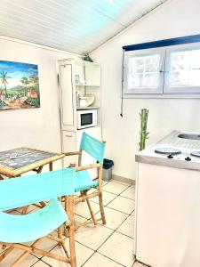 a kitchen with a table and chairs in a room at Appartement moderne à Le Lamentin avec piscine partagée - 20m² in Le Lamentin