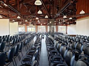 an empty room with black chairs in a building at FECEP Pousada - 5 minutos a pé da praia in Guaratuba +52 photos