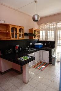a kitchen with a black counter top in a room at Spacious Apartment in Pamplemousses with Private Pool in Pamplemousses Village
