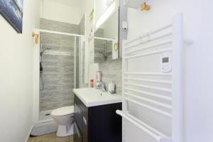 a bathroom with a sink and a toilet and a shower at Le chant de la garonne in Saint-Béat +96 photos