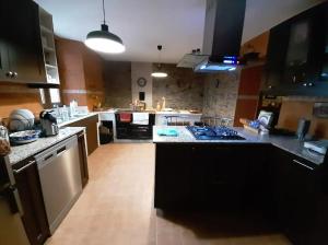 a large kitchen with a counter top and a kitchen island at Spacious villa with pool in Empalme de Vilar - 300 m², 8 guests in Vilar