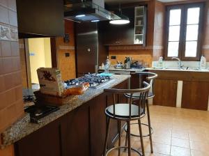 a kitchen with a counter with two bar stools at Spacious villa with pool in Empalme de Vilar - 300 m², 8 guests in Vilar +20 photos