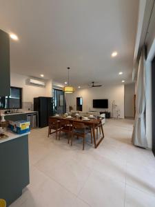 a kitchen and living room with a table and chairs at Villa Manu in Ko Phangan