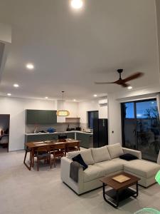 a living room with a couch and a table at Villa Manu in Ko Phangan