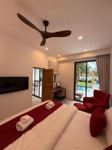 a bedroom with a large bed and a ceiling fan at Villa Manu in Ko Phangan +27 photos