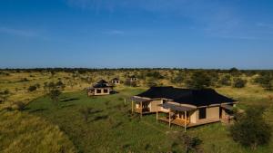an overhead view of a group of tents in a field at Bushland Luxury Camp in Serengeti