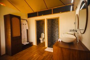 a bathroom with a sink and a toilet at Bushland Luxury Camp in Serengeti