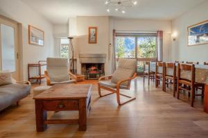 a living room with a couch and chairs and a fireplace at Chalet confortable à Briançon avec vue sur montagne in Briançon