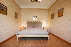a bedroom with a bed and two night stands at Chalet confortable à Briançon avec vue sur montagne in Briançon