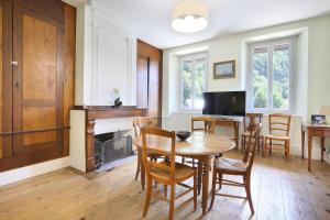 a kitchen and dining room with a table and chairs at Le chant de la garonne in Saint-Béat