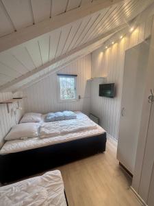 a bedroom with two beds in a attic at Sønderborg Wellness Villa in Skovbyballe