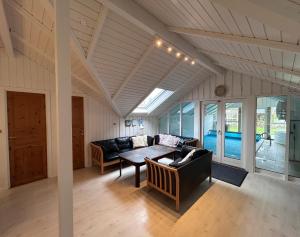 a living room with a couch and a table at Sønderborg Wellness Villa in Skovbyballe