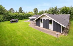 a house with a large yard with a building at Sønderborg Wellness Villa in Skovbyballe