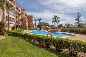 a swimming pool in a yard next to some buildings at Inmacanela playa in Isla Canela