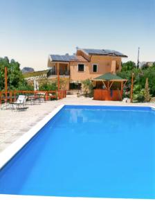 a villa with a swimming pool in front of a house at Spacious villa with private pool and stunning views in Bompensiere