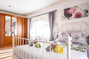 a bedroom with a white bed and a window at Elegant Villa in Ciutadella de Menorca with Private Pool in Sa Caleta