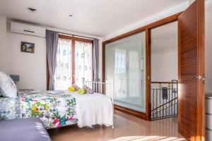 a bedroom with a bed and a large window at Elegant Villa in Ciutadella de Menorca with Private Pool in Sa Caleta