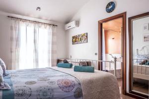 a bedroom with a large bed and a mirror at Elegant Villa in Ciutadella de Menorca with Private Pool in Sa Caleta