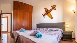 a bedroom with a bed with blue towels on it at Elegant Villa in Ciutadella de Menorca with Private Pool in Sa Caleta +15 photos