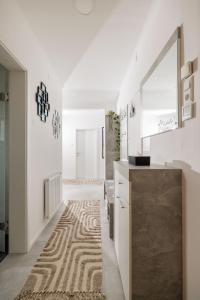 a kitchen with white walls and a rug on the floor at Ferienwohnung Leibnitz Südsteiermark in Leibnitz