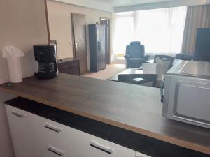 a kitchen with a microwave and a living room at Apartment 231 in Hohegeiß