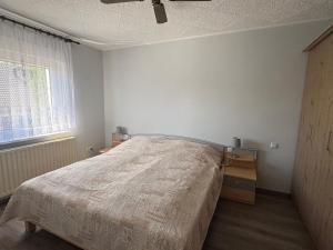 a bedroom with a bed and a dresser and a window at Ferienwohnung Nordstadt in Forst