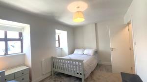 a small bedroom with a crib and a window at 17 Clifden Court in Clifden