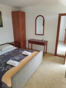 a bedroom with a bed with a desk and a mirror at Cosy Apartment in Ulcinj with Sea View - 40 m² in Ulcinj
