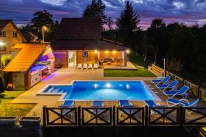 a swimming pool with chairs and a house at Peaceful Villa in Gornje Dubrave with Private Pool in Gornje Dubrave
