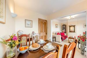 a dining room and living room with a table and chairs at 1 Bed in Appledore oc-captv in Appledore