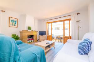 a living room with a blue couch and a fireplace at PDM CA'N NOFRE in Playa de Muro