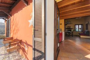 an open door of a house with a patio at Charming Villa with Private Pool in Vesime in Vesime
