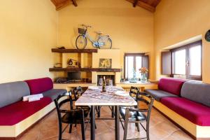 a living room with a table and a bike on the wall at Charming Villa with Private Pool in Vesime in Vesime +9 photos